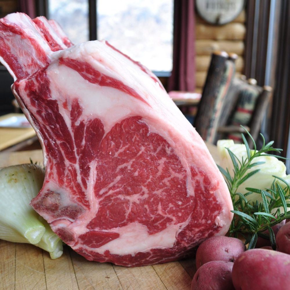 A dry-aged Wagyu bone-in rib roast on a butcher block